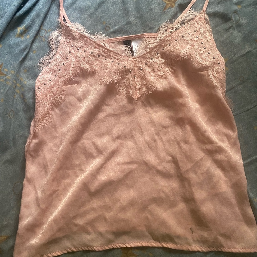 Check out this adorable pink top that brings a touch of sweetness to any outfit!